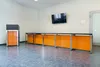 Комплект президиума Техно с оранжевым фасадом в демонстрационном зале производства.