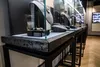 Вариант исполнения вертикальной витрины в покраске "Вороненная сталь" в интерьере.