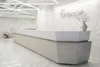 Двухуровневая стойка ресепшн РИ-153 из искусственного камня длиной 8,1м